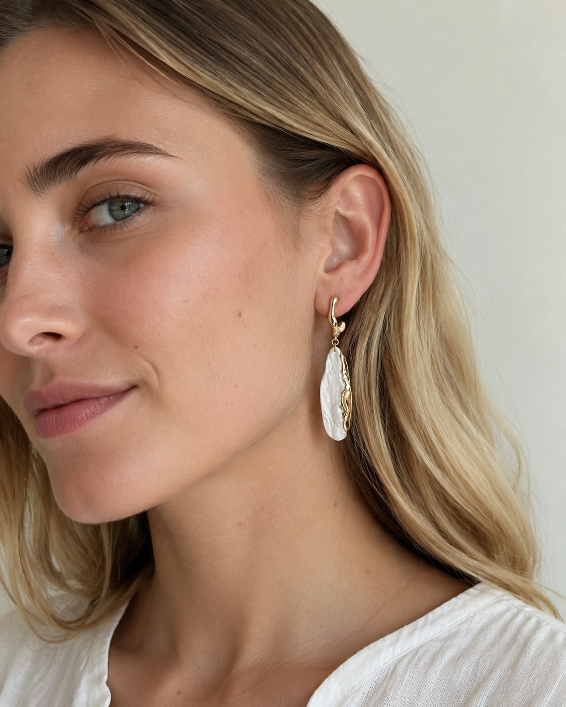 Ivory Current earrings worn by model