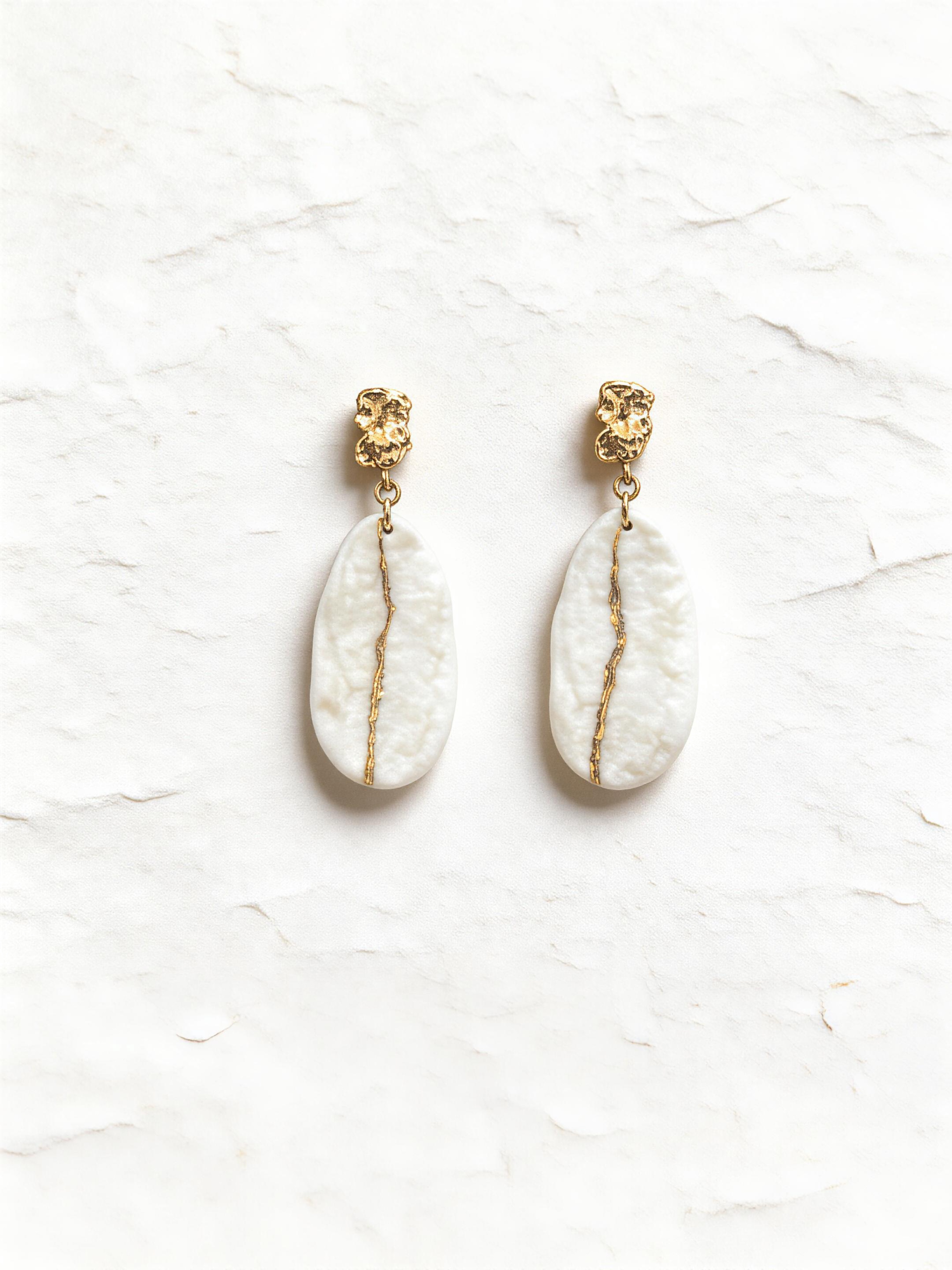 Sun-Carved Whiteness porcelain earrings with blue ceramic surface and golden organic edge