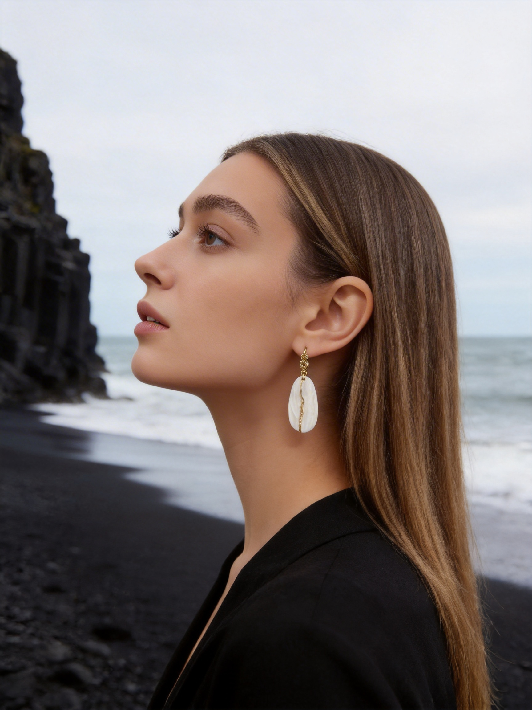 Profile view of Stone Meets Sea jewelry worn by model