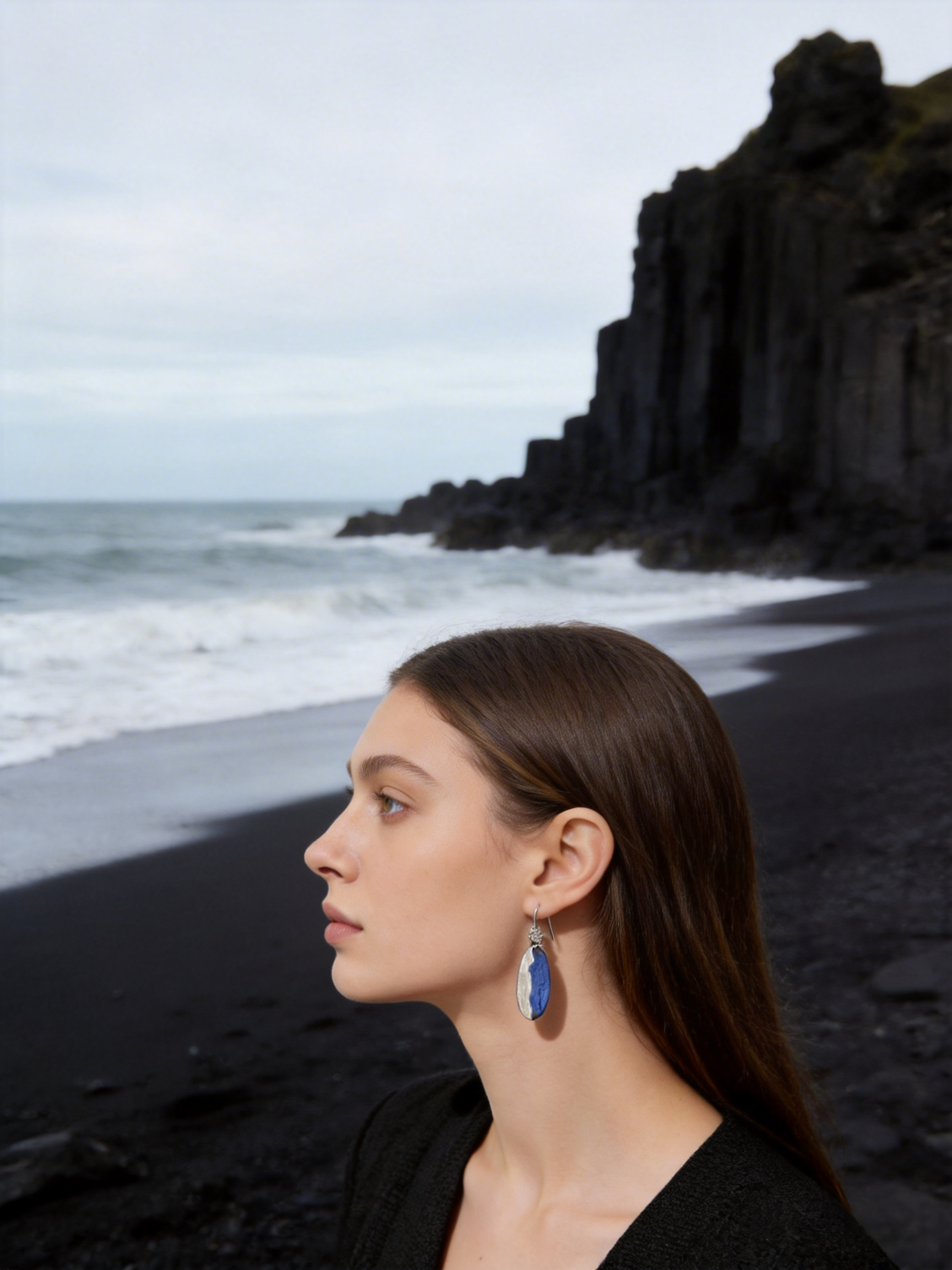 Stone Meets Sea porcelain jewelry worn by model near the sea
